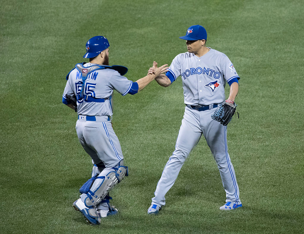 Roberto Osuna and Russell Martin celebrate